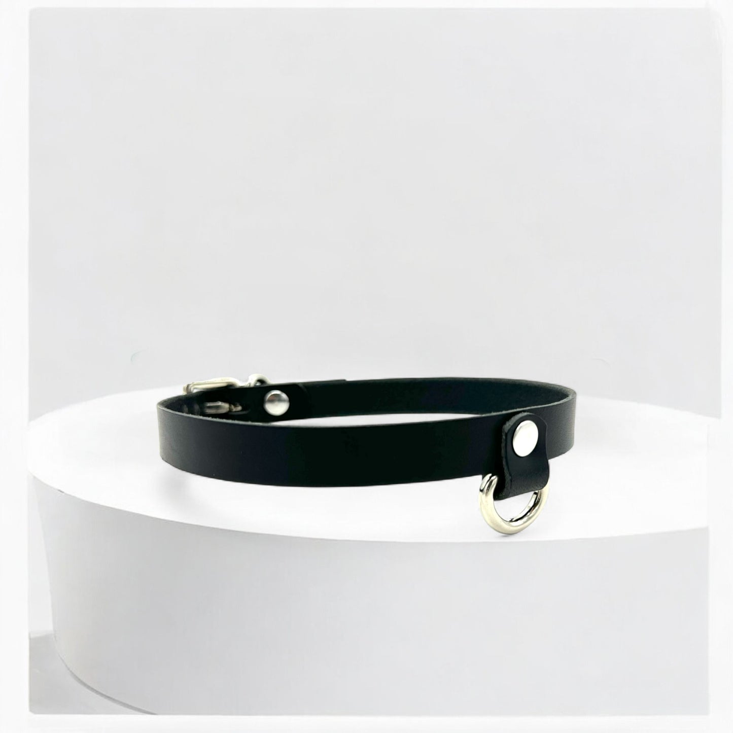 Adjustable black leather choker with small drop D-ring, crafted in New Jersey