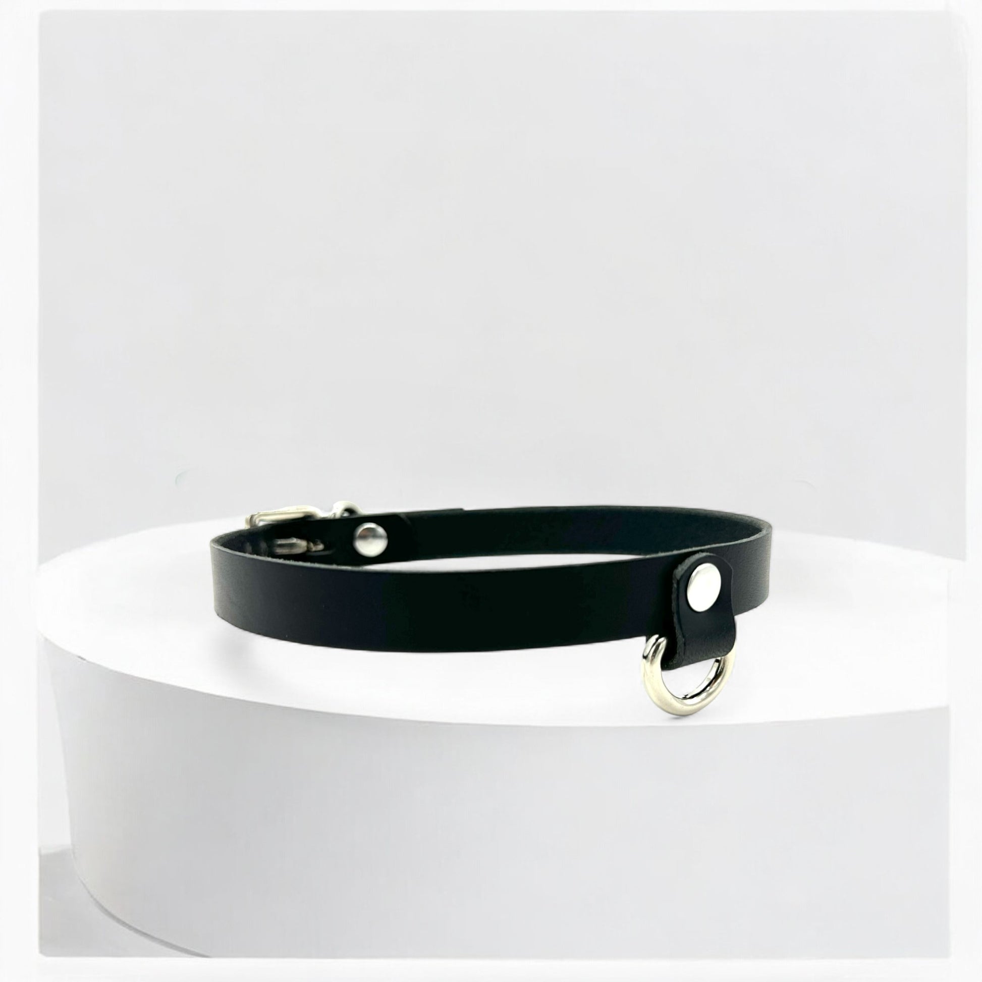 Adjustable black leather choker with small drop D-ring, crafted in New Jersey