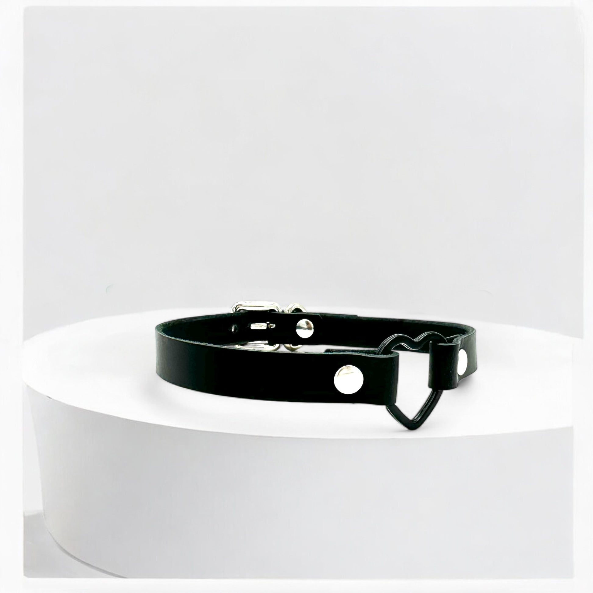 Angled view black heart choker with black hardware detail