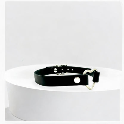 Close-up black heart leather choker with silver hardware detail