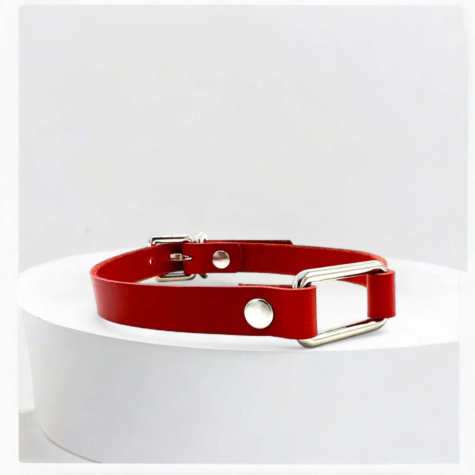 Close-up red rectangle-link leather choker with silver link detail