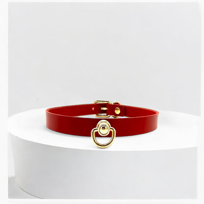 Close-up of gold O-link centerpiece on red Italian Buttero leather choker