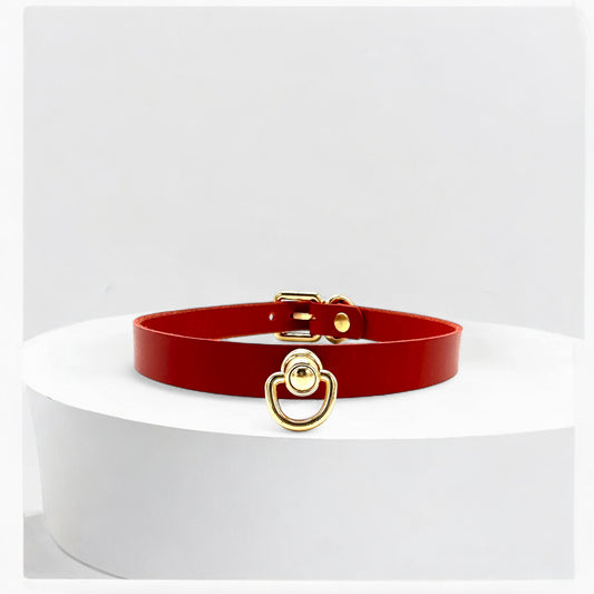 Close-up of gold O-link centerpiece on red Italian Buttero leather choker